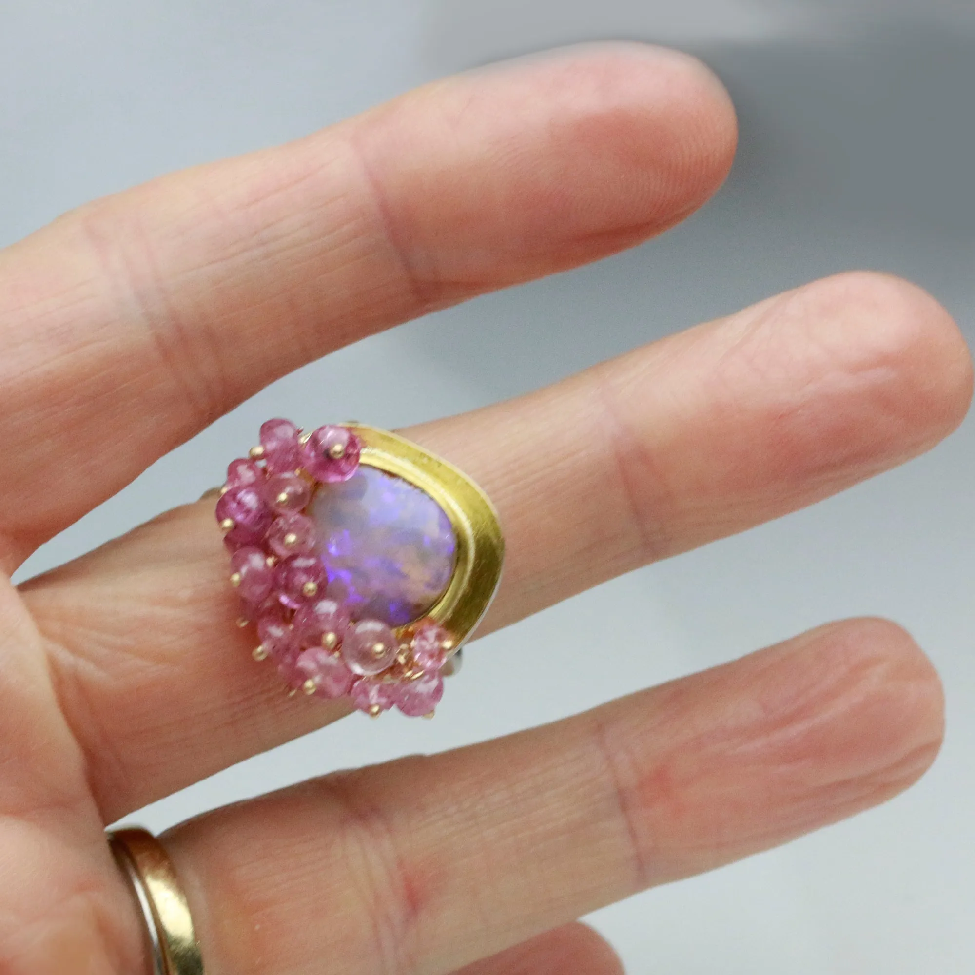 Sold Dusty Rose and UV Flash Boulder Opal with Pink Sapphire Fringe. Size 6 1/2.